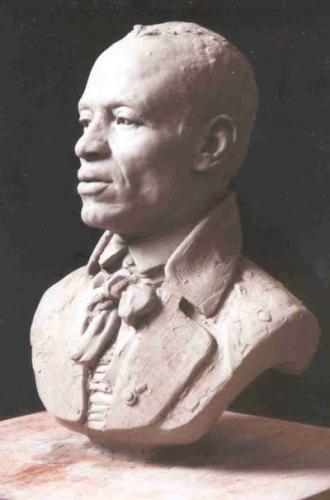 A bust of John Chavis. He has short hair and is wearing a suit jacket and scarf. 