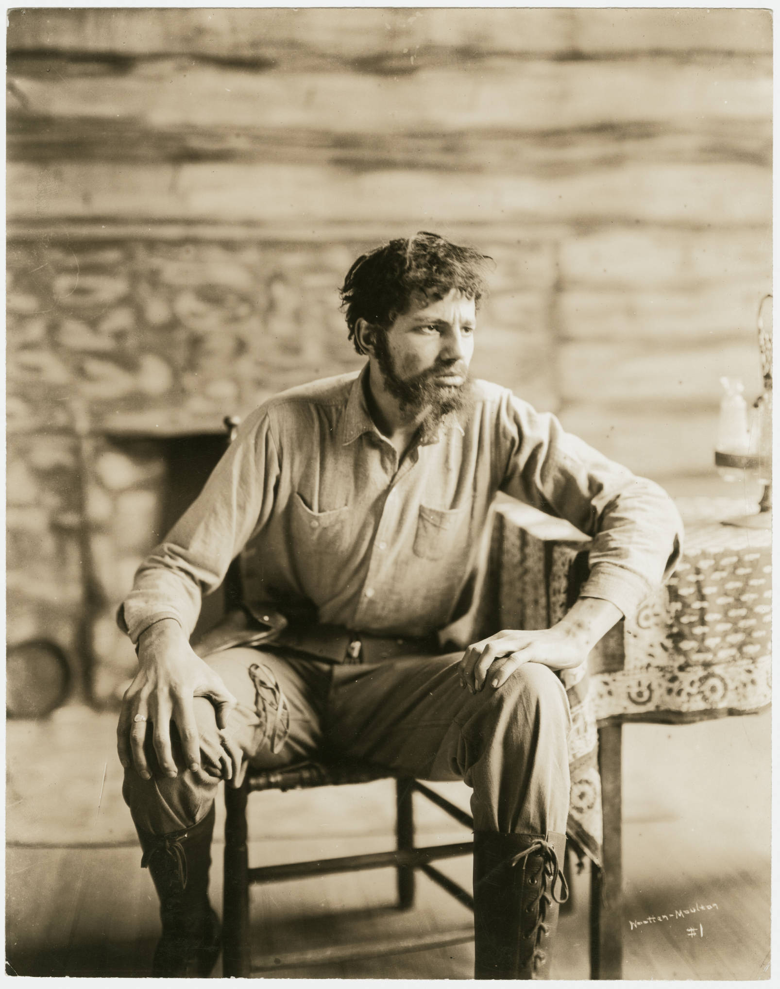 Thomas Wolfe dressed in Antebellum workers' clothes--a cloth shirt and pants with laced boots. He looks haggard with a scruffy beard and messy hair. 