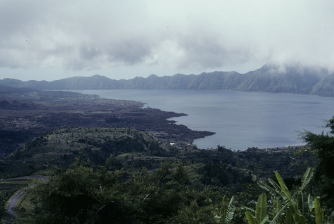 Clouds loom over the mountain rim of Lake Batur
