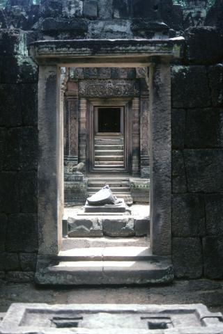 View through parallel stone doorways into central temple area at Banteay Srei